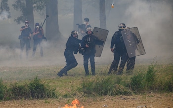 A Molotov cocktail is hurled at police on Saturday