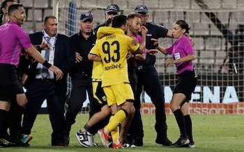 Aris's Shapi Suleymanov remo<em></em>nstrates with the referee Stephanie Frappart 